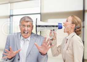Women shouting at Stressed businessman in office