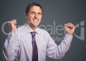 Man in lavender shirt with fists in air against grey background