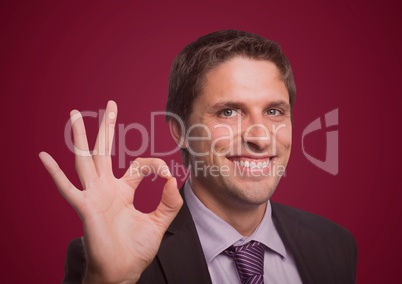 Business man three fingers up against maroon background