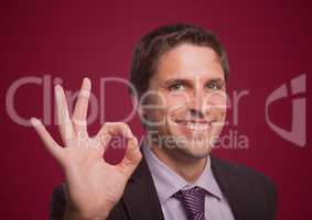 Business man three fingers up against maroon background