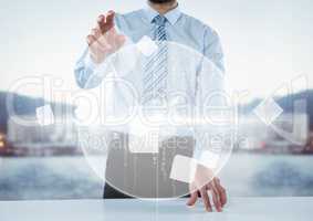 Business man at desk with white interface against blurry skyline