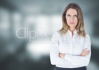 Angry disappointed businesswoman against grey blurred background