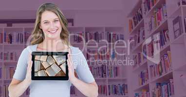Woman with tablet showing open books against blurry bookshelf with pink overlay