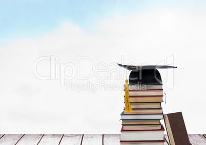 Books stacked by blue sky