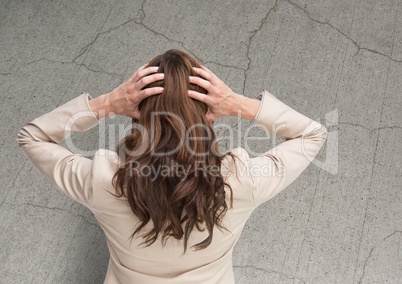 Stressed woman against cracked stone wall