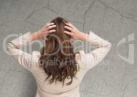 Stressed woman against cracked stone wall