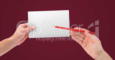 Hands holding blank card and pencil against maroon background