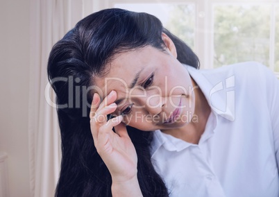 Sad worried woman by window