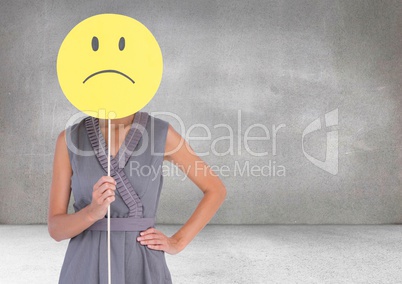 Sad woman holding face against grey background