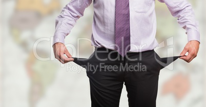 Business man pulling outpockets against blurry map