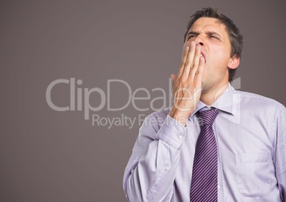 Man in lavender shirt yawning against brown grey background