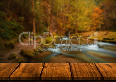 Wood table against blurry river