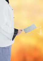 Chef with cleaver against blurry orange background
