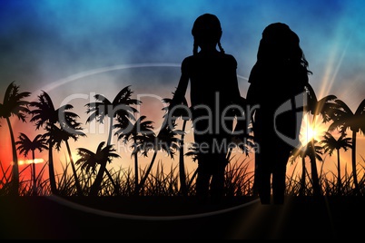 Silhouettes of  kids holding hands against sunset view with palm trees