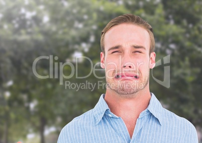 Man crying against trees