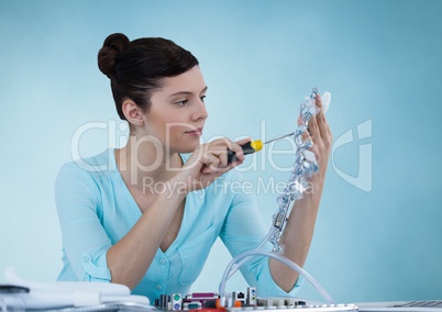 Woman with electronics against blue background