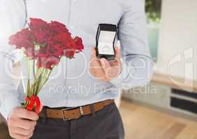 Man holding engagement ring and flowers in room