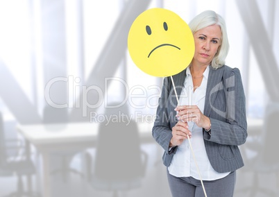 Sad businesswoman against bright office
