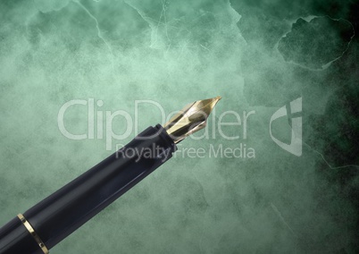 Fountain pen gold tip against green classic background