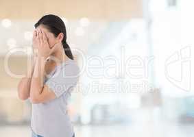 Sad woman grief hands over face against bright background