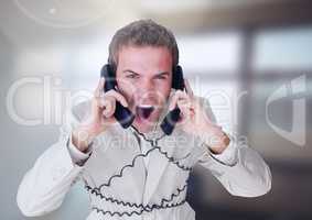 Stressed man on telephones in office