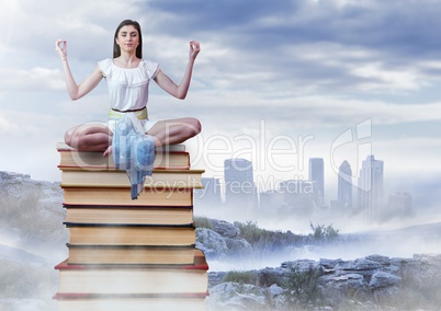 Woman meditating sitting meditating on Books stacked by distant city
