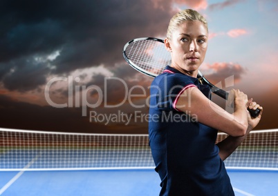Tennis player on court with evening sky