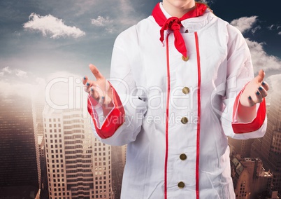 Chef with hands out against blurry skyline