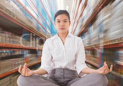 Businesswoman Meditating against motion blur background