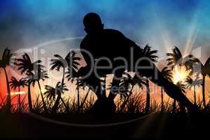 Silhouettes of  player with ball  against sunset view with palm trees