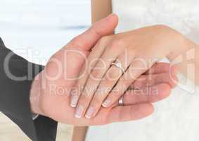 Bride and groom hands at blurry beach