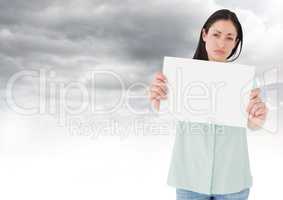 Sad woman holding blank card against clouds