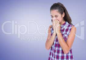 Girl blowing her nose in tissue with purple background