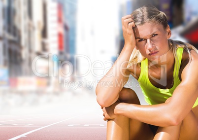 Sad disappointed athlete runner sitting down in city