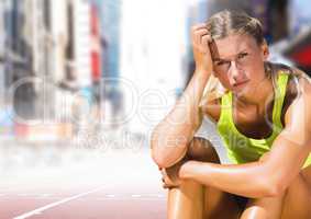 Sad disappointed athlete runner sitting down in city