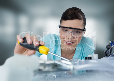 Woman with electronics in blurry grey room