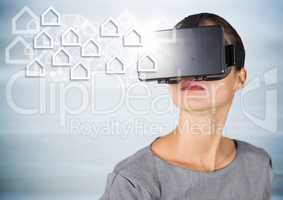 Woman in VR with white house graphics against grey wood panel