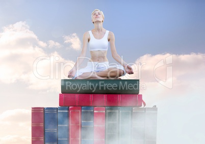 Woman meditating relaxing on Books stacked by sky