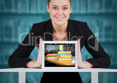 Business woman with tablet showing book pile against blurry bookshelf with blue overlay