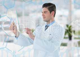 Man in lab coat holding up glass device against blue medical interface and blurry office