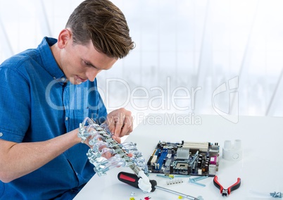 Man with electronics against blurry window