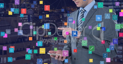 Businessman pointing with phone against Night city with connectors