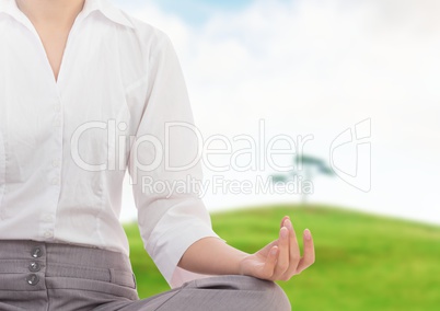 Woman Meditating by green hill and tree