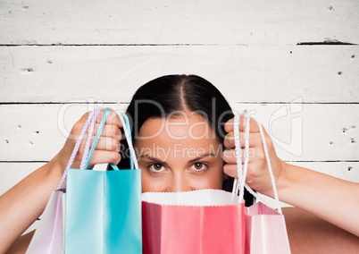 Woman with shopping bags against white wood panel