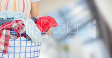 Woman in apron with laundry against blurry window