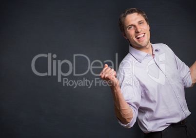 Man in lavender shirt holding up fist against navy chalkboard