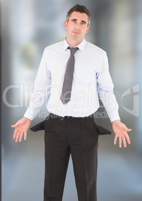 Businessman with empty pockets against blurred background