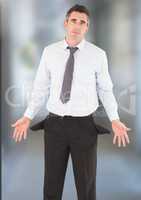 Businessman with empty pockets against blurred background
