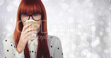 Close up of woman with coffee cup over face against white bokeh
