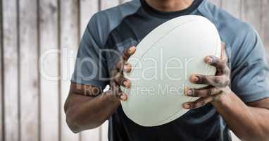 Rugby player mid section against blurry wood panel